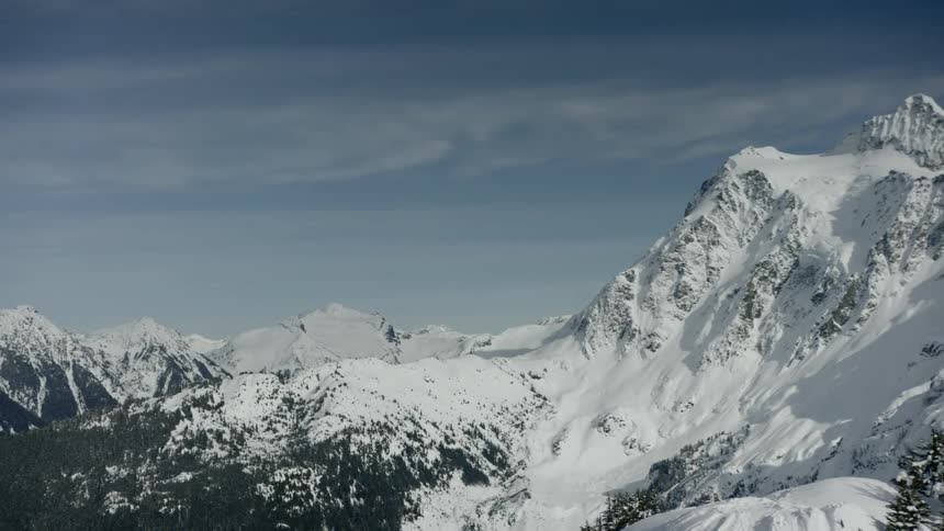 A snowy mountain ridge during the day