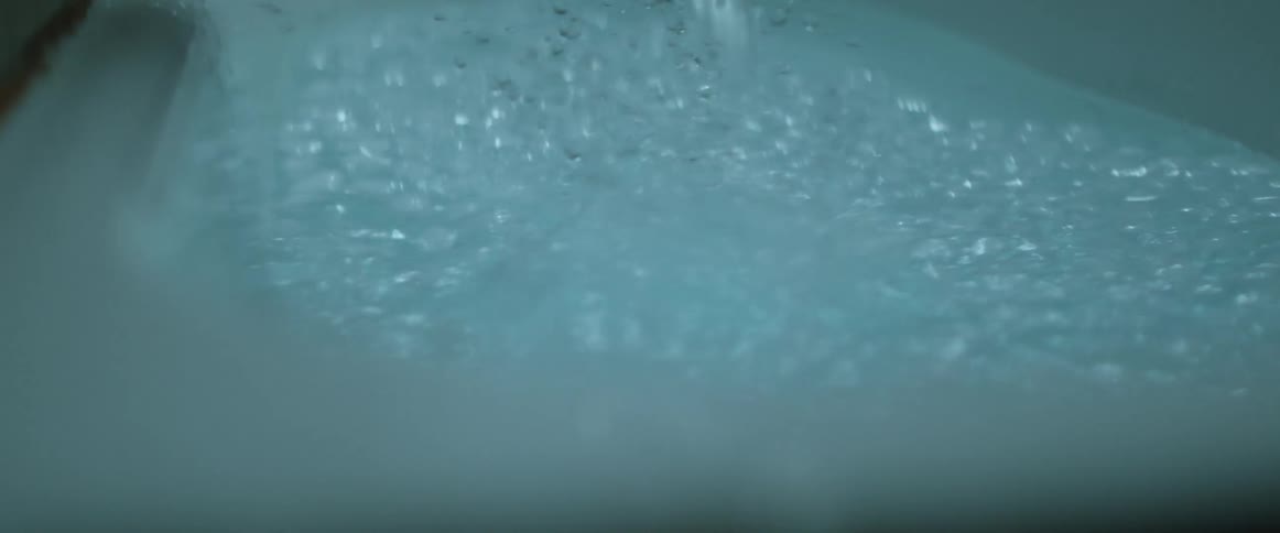 The water drops into the pool creating splashes