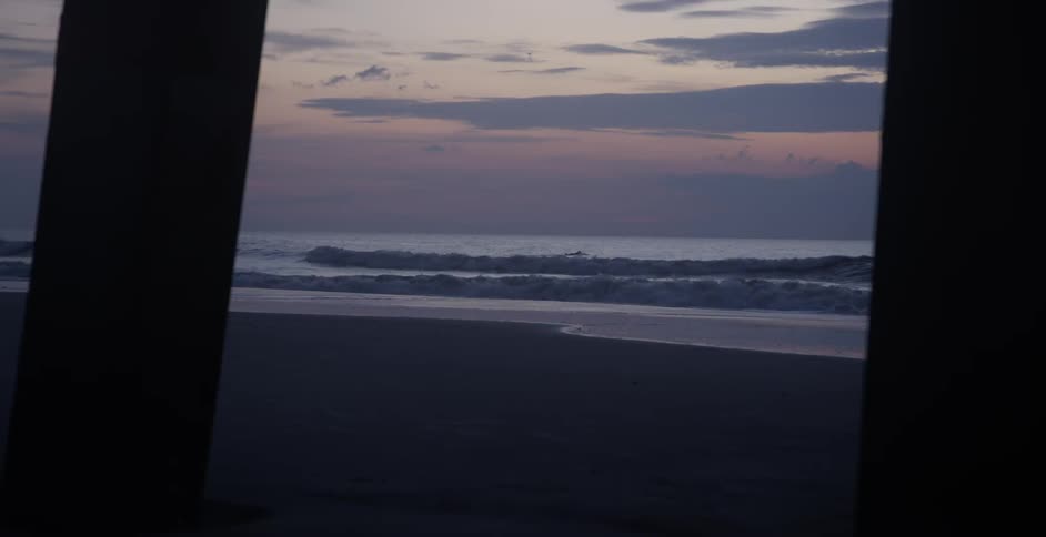 A scenery of tide on the beach at the sunset