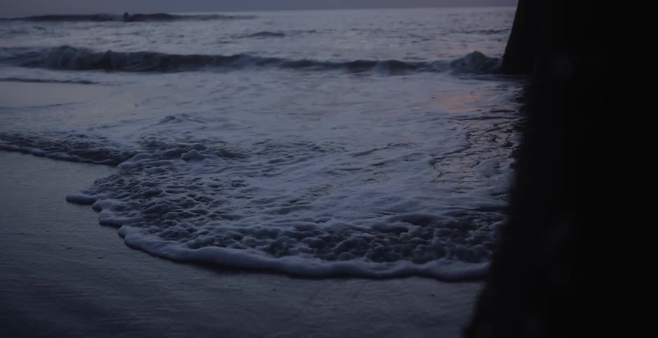 A footage of waves hitting the beach sand