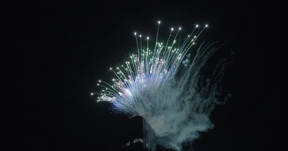 Fireworks exploding from the high rise building