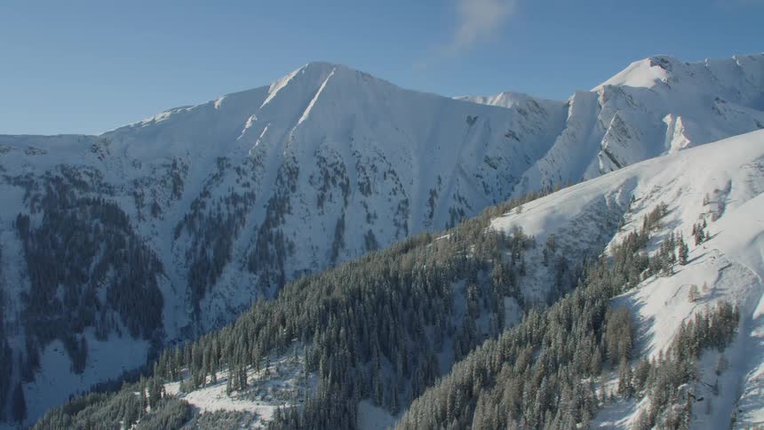 A snowy mountain ridge during the day