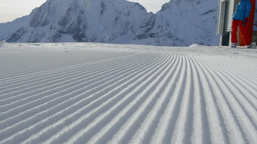 A person snowboards in the snow