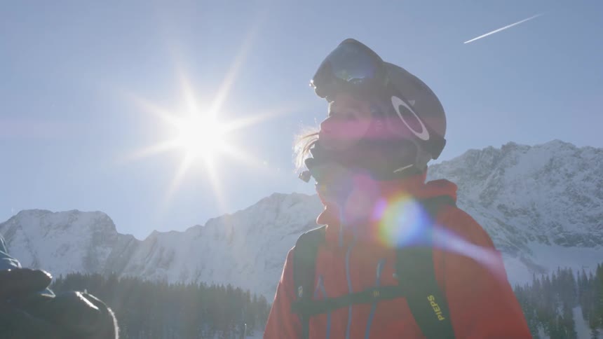 A female skier giving a male skier a high five