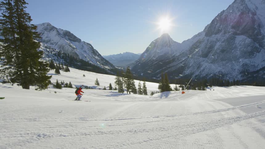 A man skiing downhill at the mountain