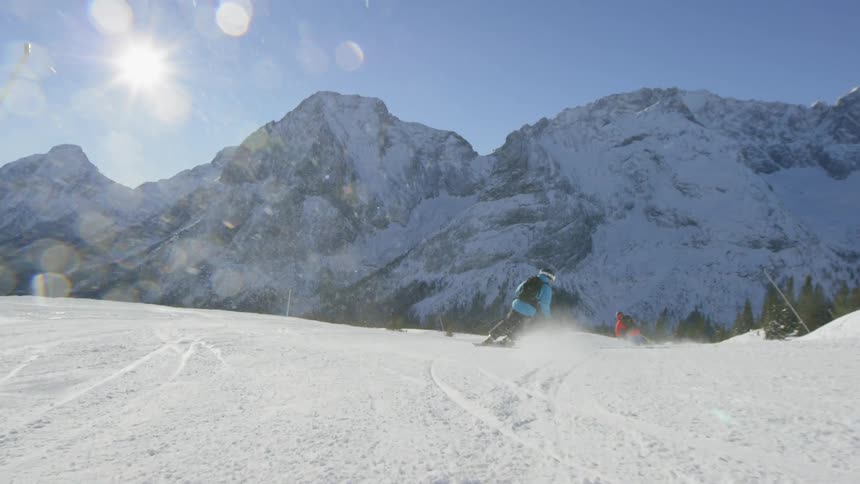 People ski down the mountain