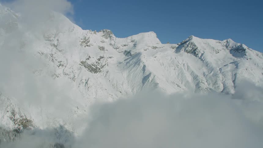 Snow covered mountains dominate the view