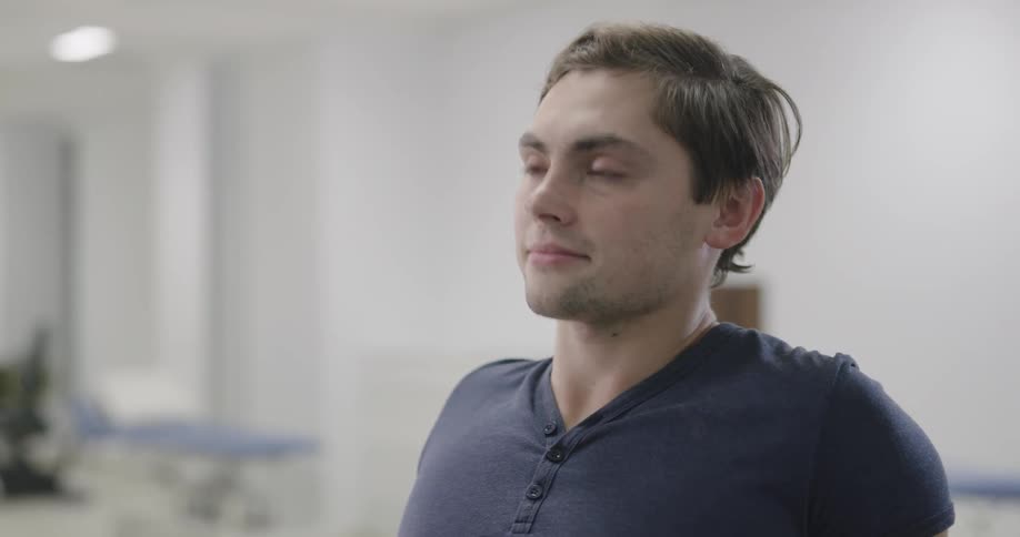 A person is in a room nodding his head
