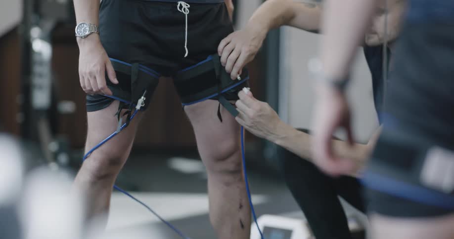 A person is being wired up by a technician