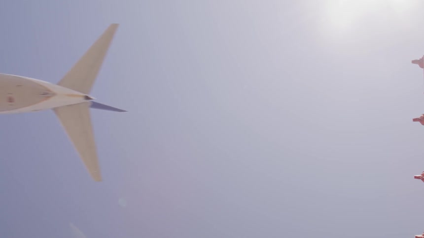 An airplane is flying in the clear blue sky