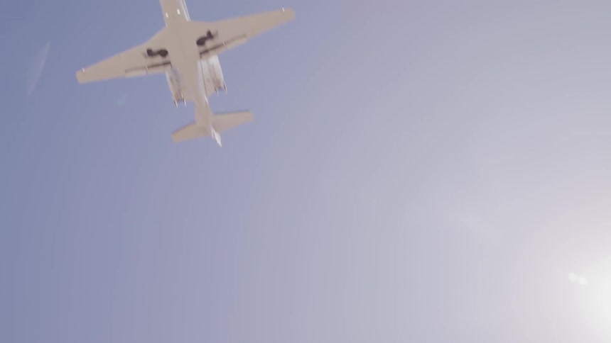 Worms view of airplane taking off on sunny day