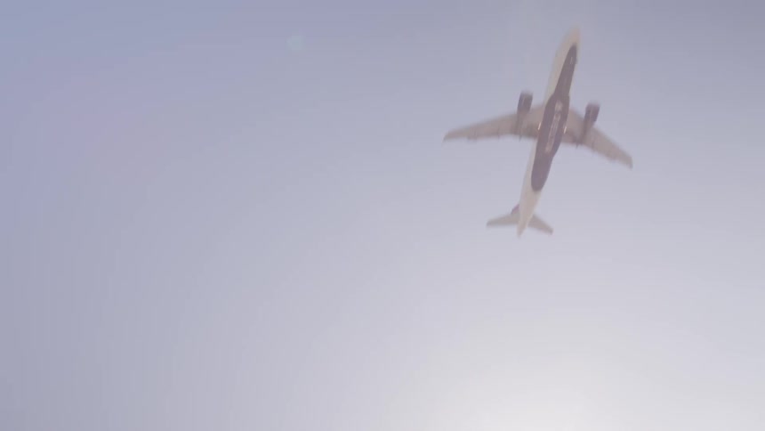 Commercial passenger plane flying across in the sky