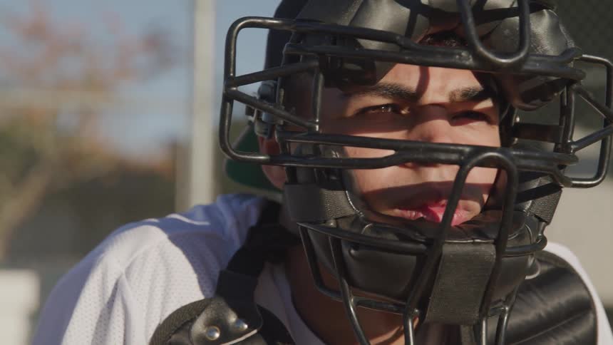 A portrait of a young man with helmet as the baseball catcher