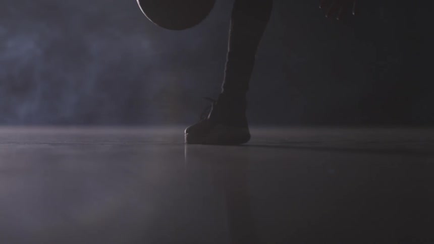 A person dribbles a basketball