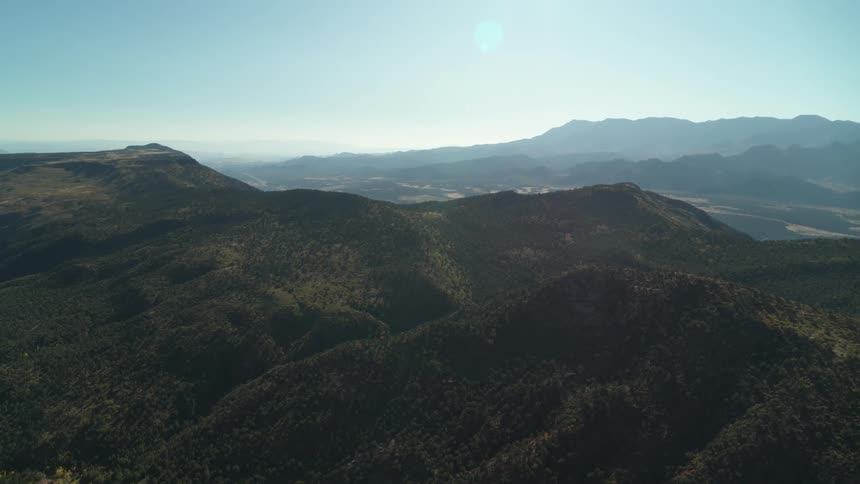 An aerial view of a mountain peak on a clear day
