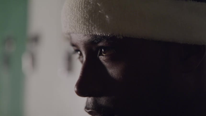 A young man in headband raising his head