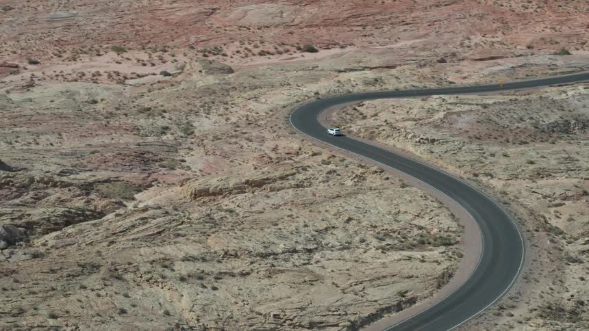 A vehicle is driving around the snakey road