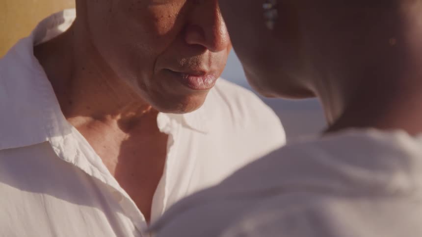 An old couple kissing their forehead