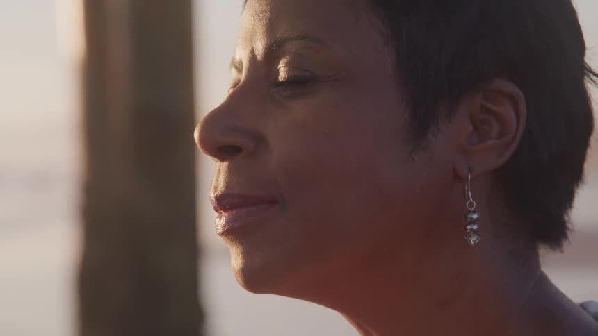 A woman smiles on a sunny day