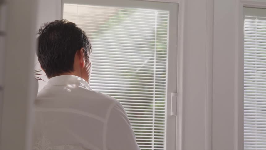 A man stares out the window