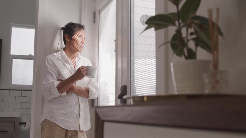 A portrait of a man looking through the window