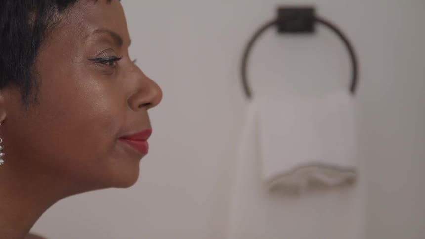 A woman is standing in a bathroom