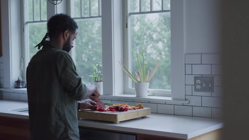 A man preparing dishes on the kitchen