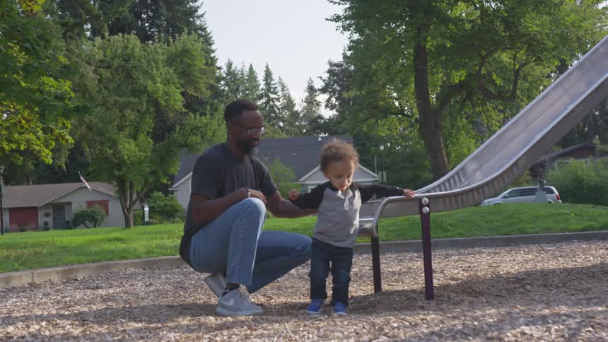 Father and son playing in the play ground