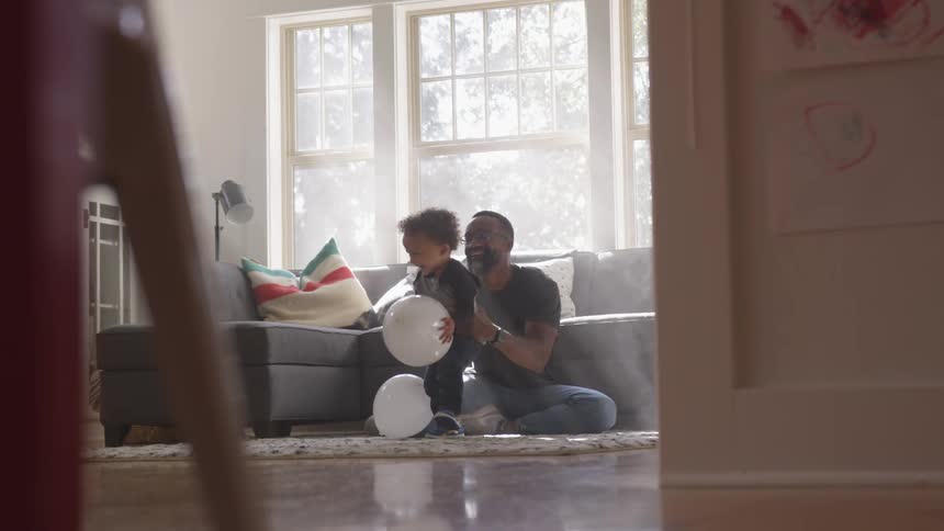 Father and son playing in the living room