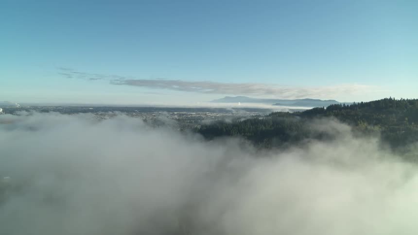The dense clouds float over the mountains