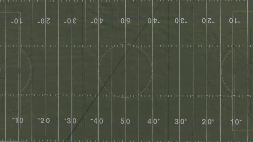 Olive green football field numbered from one end to the other