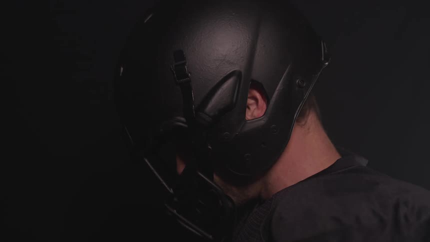 A man looks down in his helmet