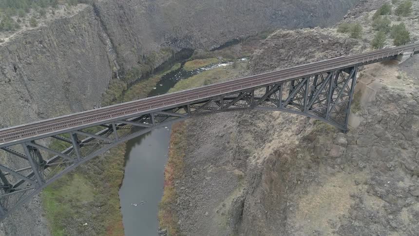 An empty arch railroad bridge over a canyon