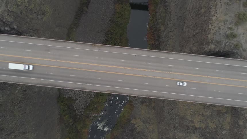 A bridge over a river running through a ravine