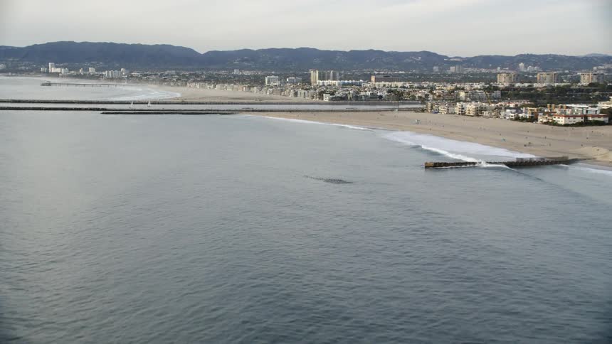 Docks and piers stretch out into the ocean as waves come to shore