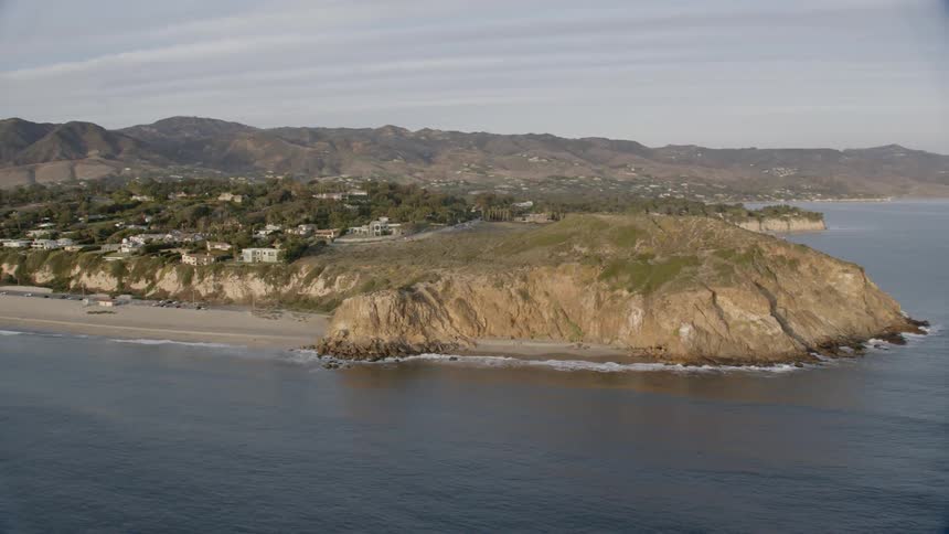 Waves are moving towards the coastline in Malibu, CA