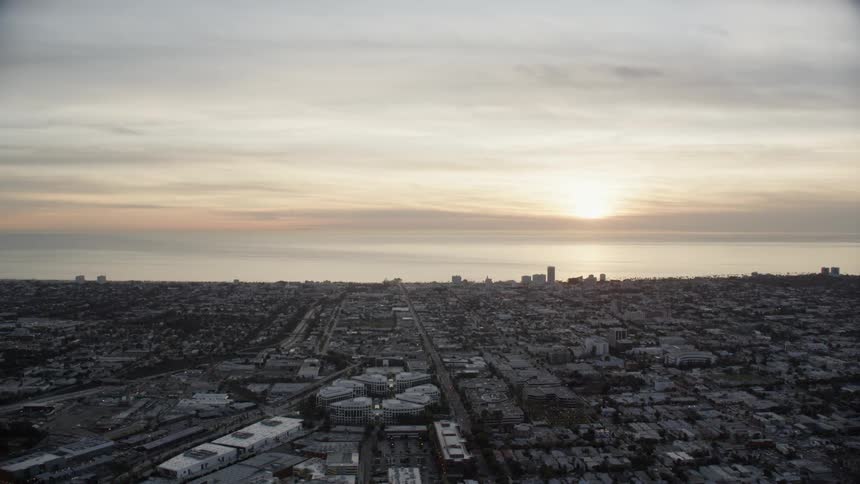 The sun is setting over the large city