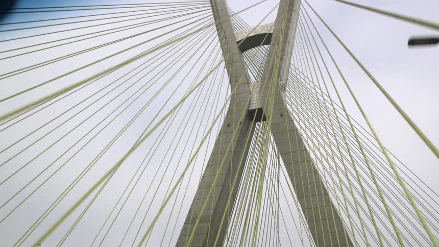 Passing under a yellow wired bridge
