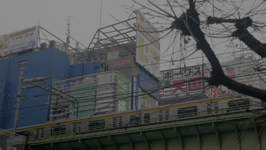 A train passes the city buildings