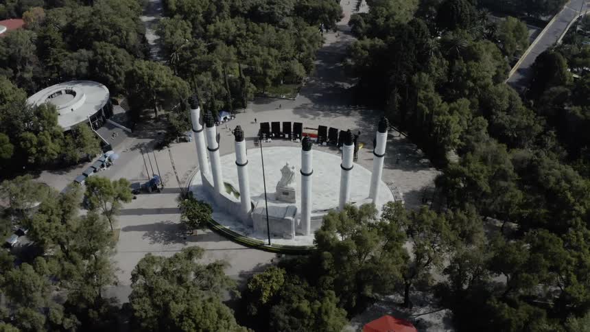 A monument in a park surrounded by trees