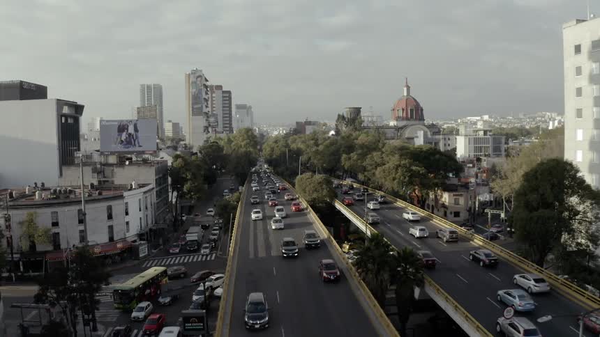 Traffic moves across elevated roads in a bustling city