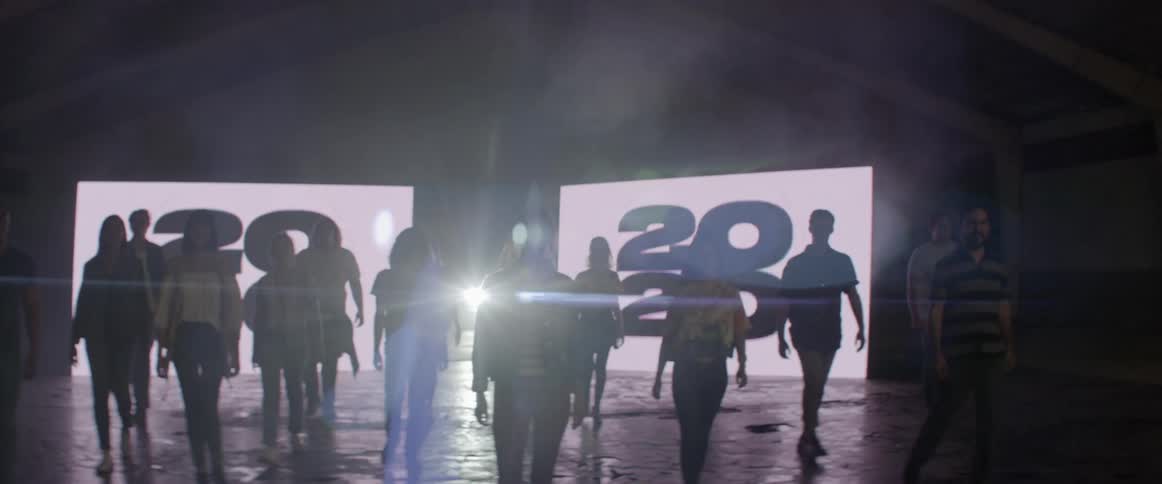People walks toward the camera from the stage
