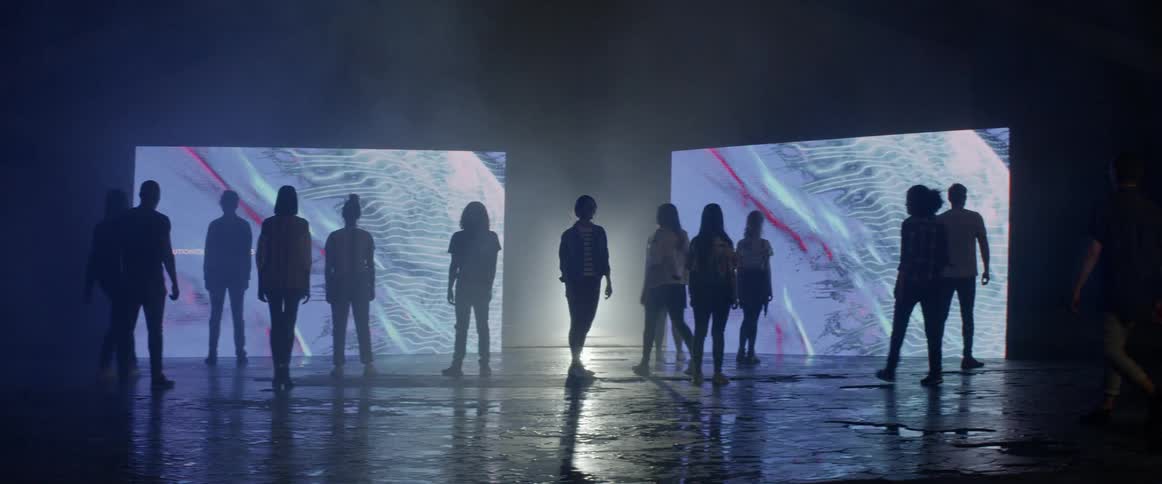 The people gather around watching the flashing screens