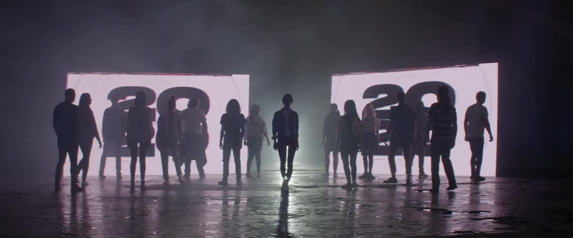 People spin to walk away from large screens