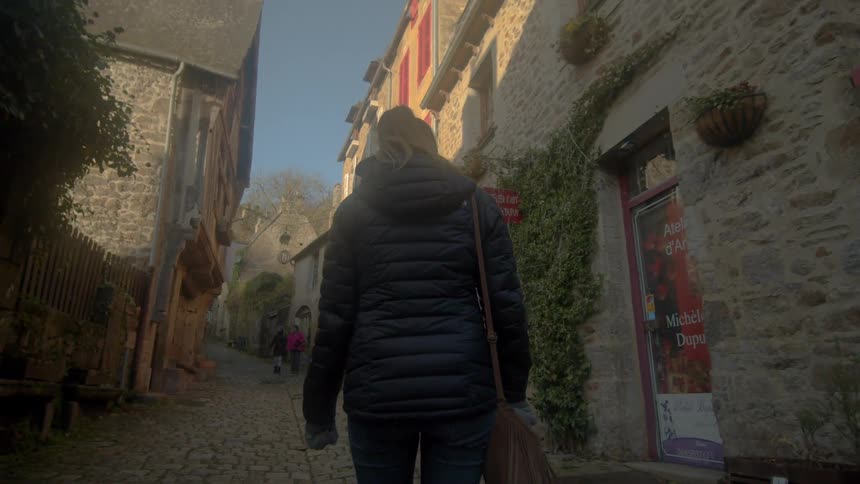 A woman walks in the rural city