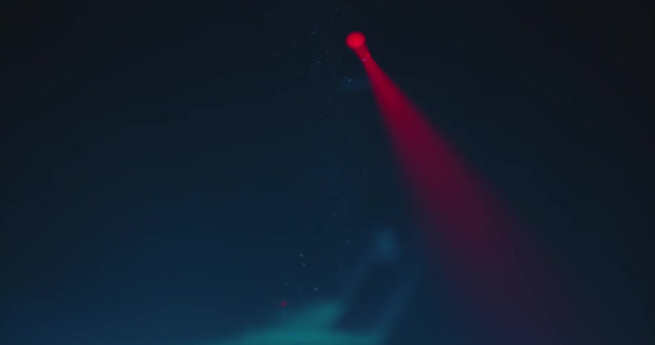 Laser red beam going through bubbling liquid