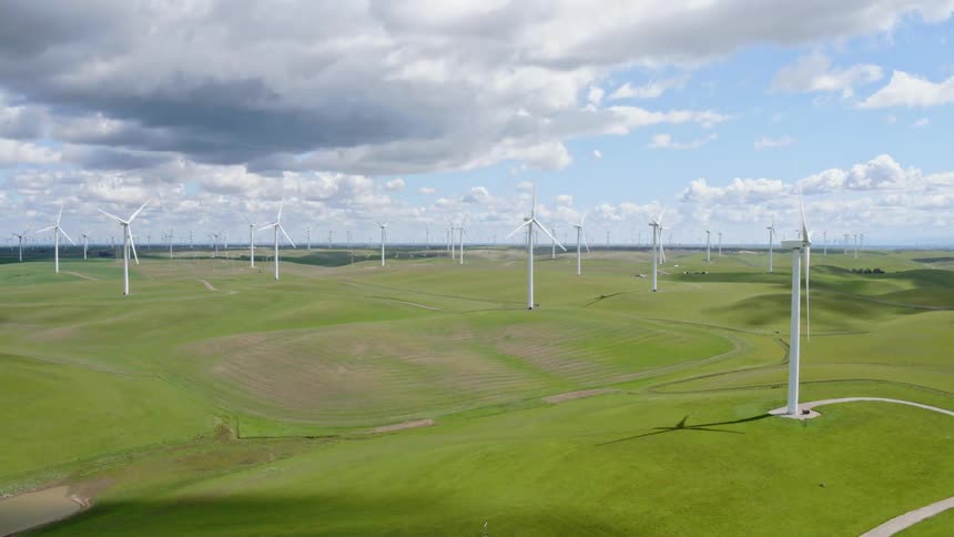 A scenery of a wind turbine on wide grass field