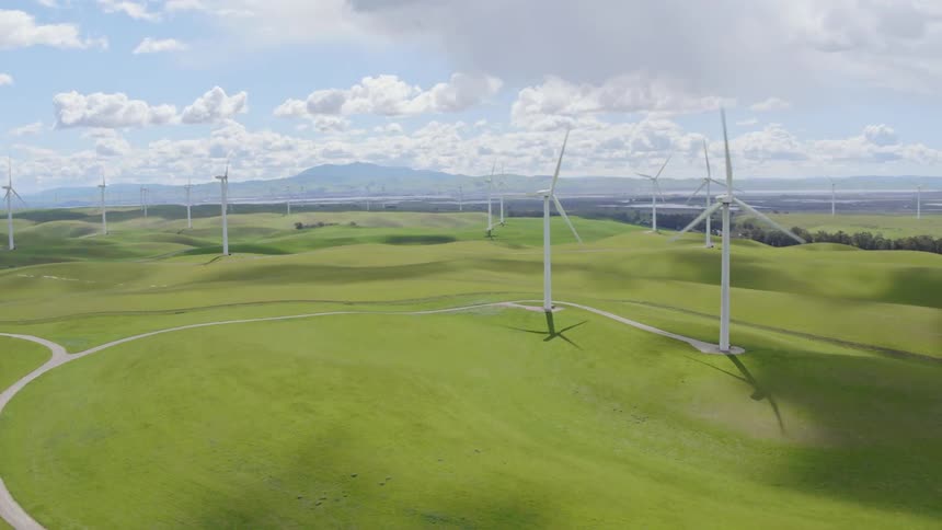 Wind turbines spin in a large open field