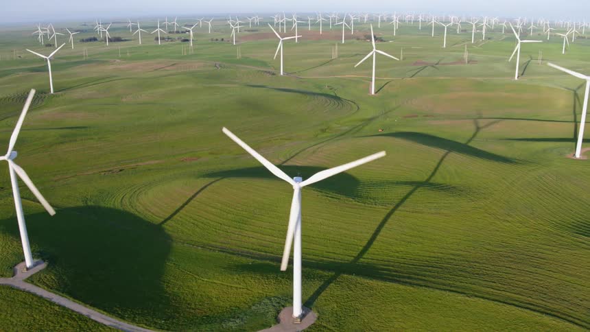 Wind turbines spin in a large field