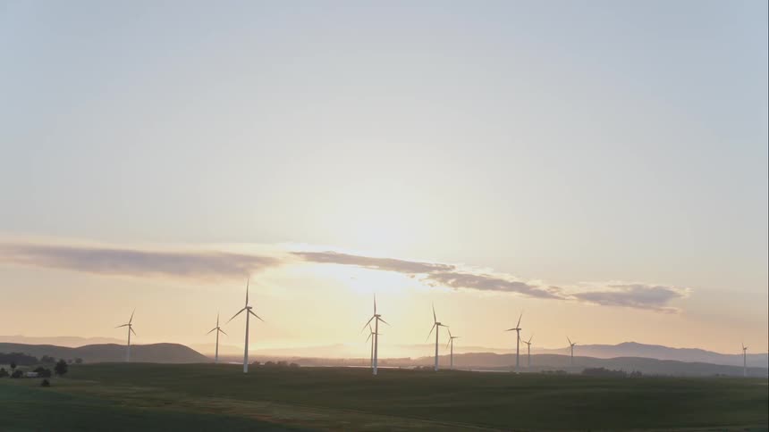 Wind turbines spin on a wind farm